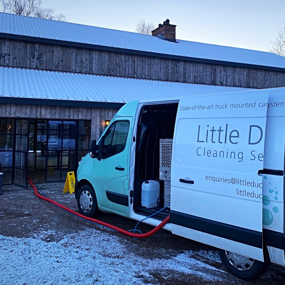 Little Duck Van on a snowy day with a cleaning hose running into a building
